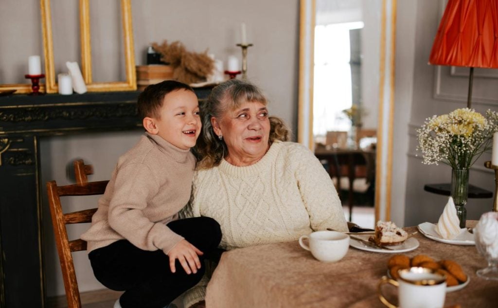 grandson and grandmother at table