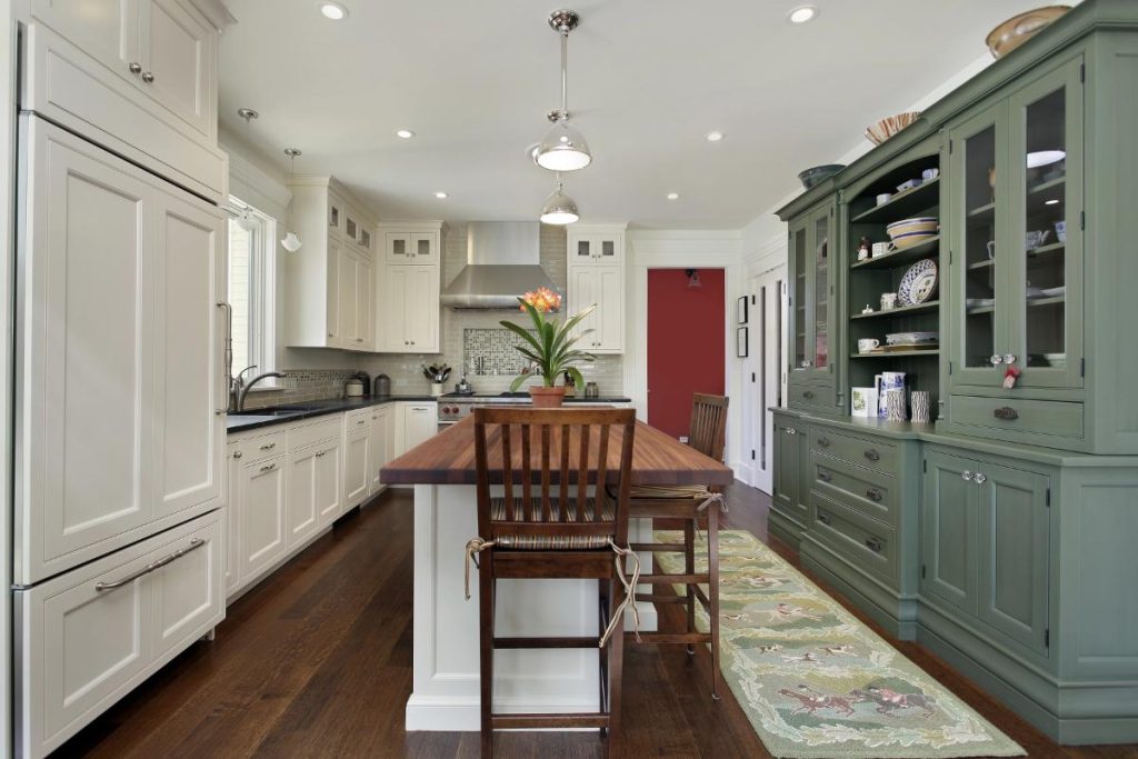 kitchen with white cabinets on one side and green cabinets or cupboard on the other