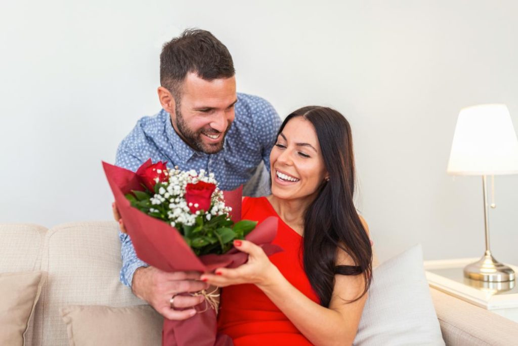 man giving his wife flowers for an anniversary