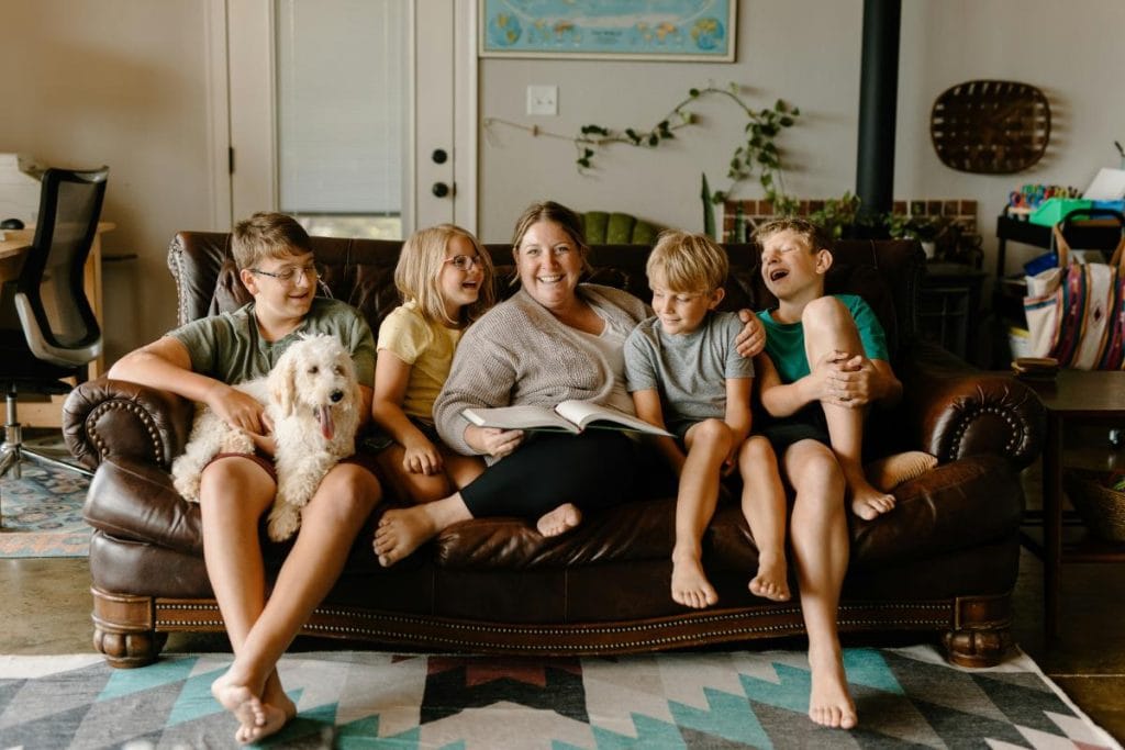 family sitting on sofa with dog