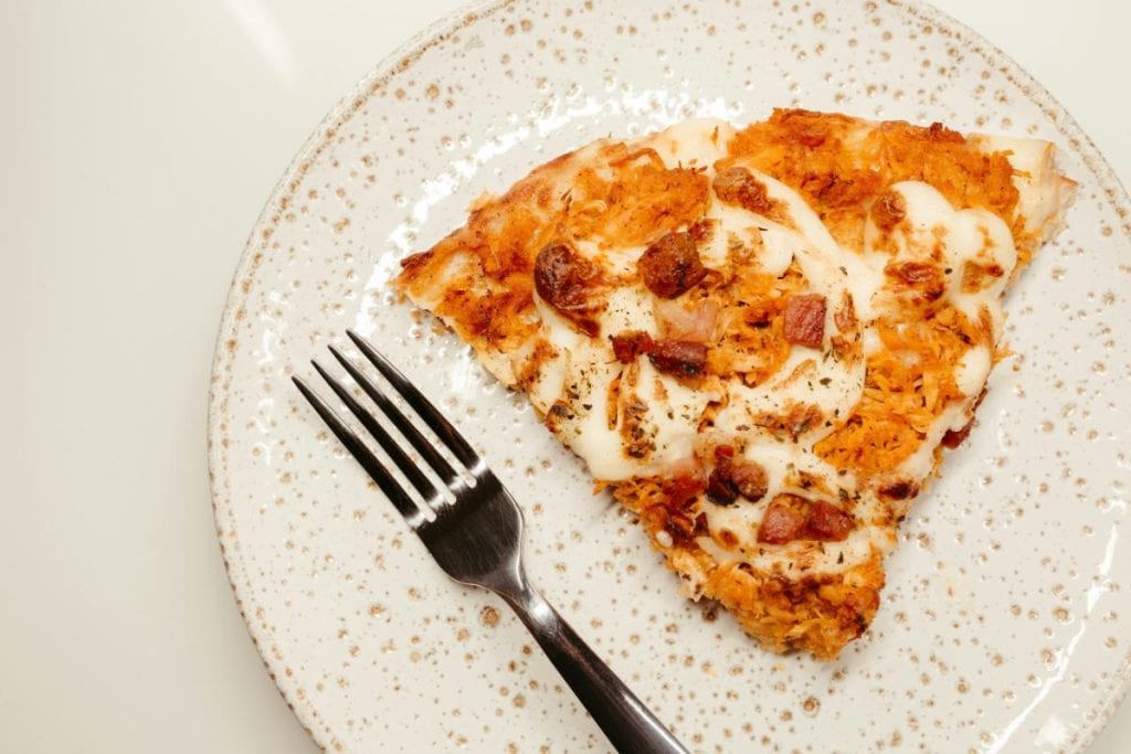 pizza on a plate with a fork