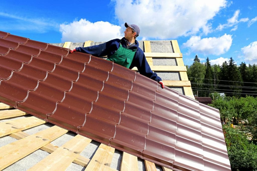 roofer installing metal roof