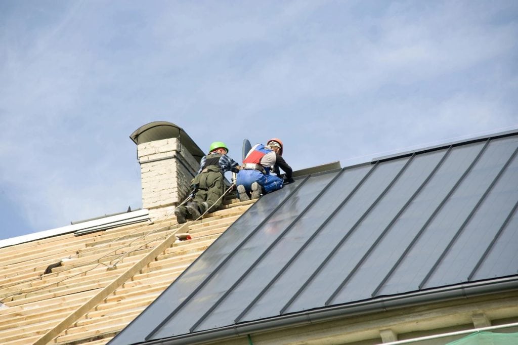 roofers installing a metal roof