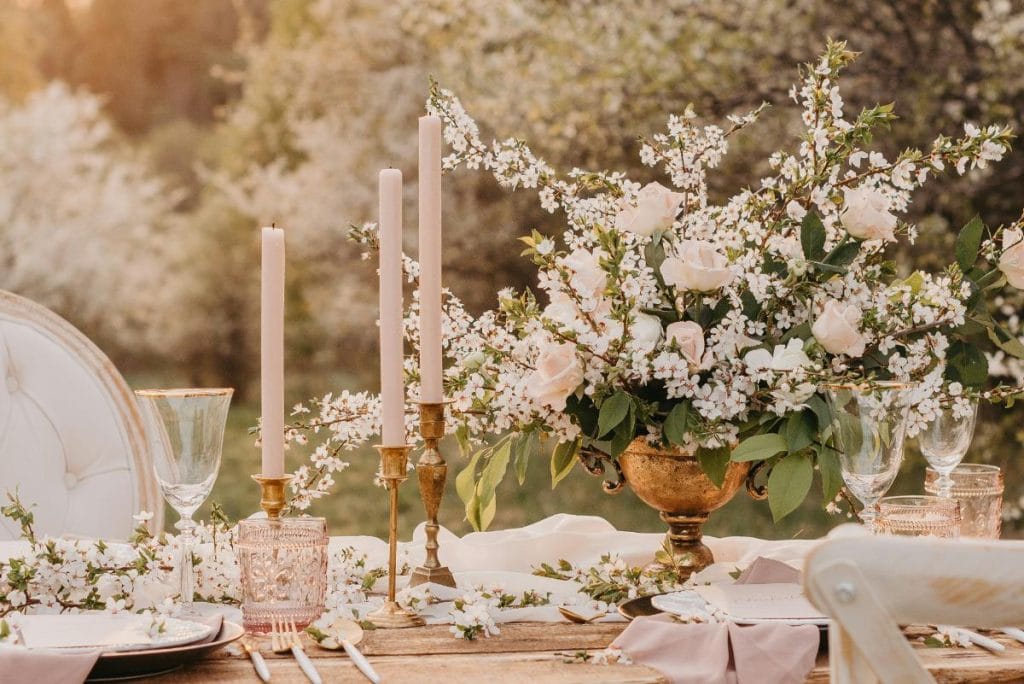 pretty wedding table with flowers and candlesticks