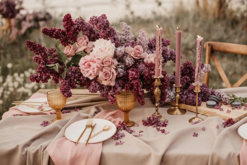 a beautiful wedding table setting in various shades of pink