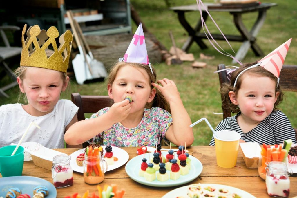 3 girls snacking at a birthday party