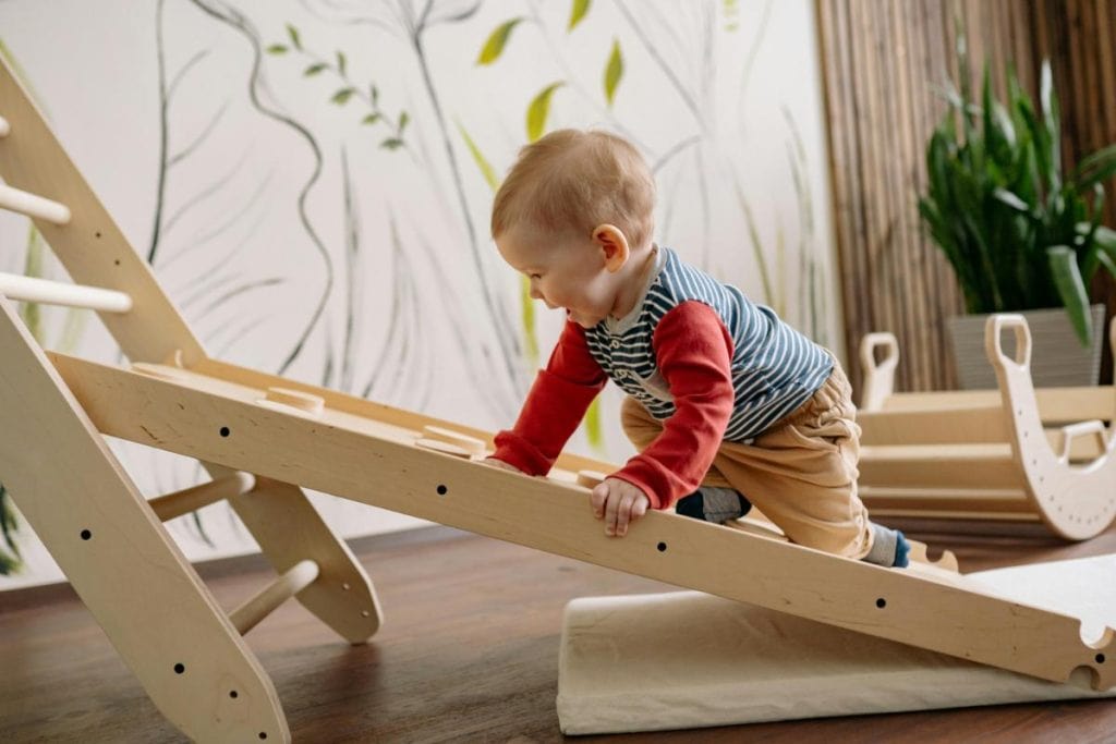 baby boy on climbing toy