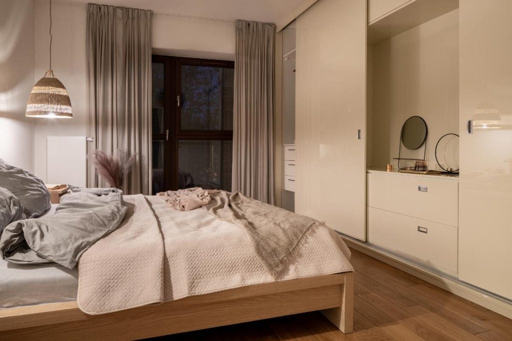 bedroom with a sliding door hiding a wardrobe