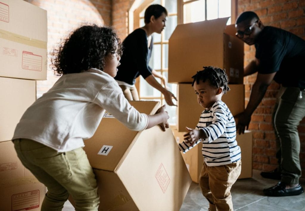 children helping parents pack moving boxes