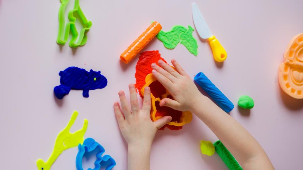 a child's hands playing with playdough - overhead picture