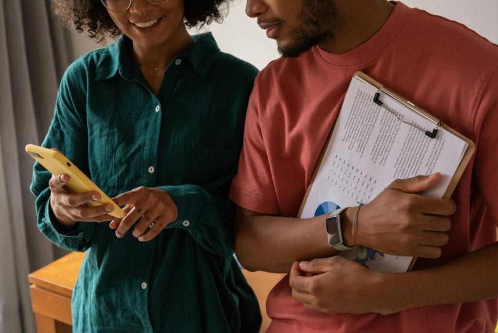 couple with clipboard and phone examining their finances