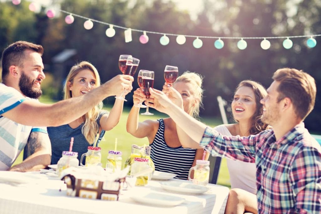 friends clinking glasses at a garden party