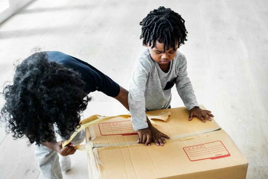 little boy helping with packing a box