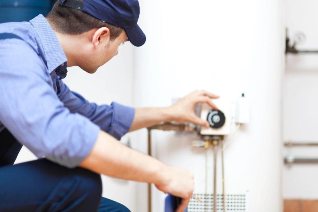 repairman adjusting a water heater