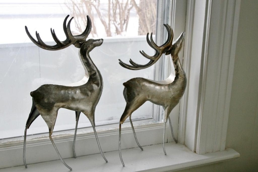 metal reindeer sculptures in windowsill