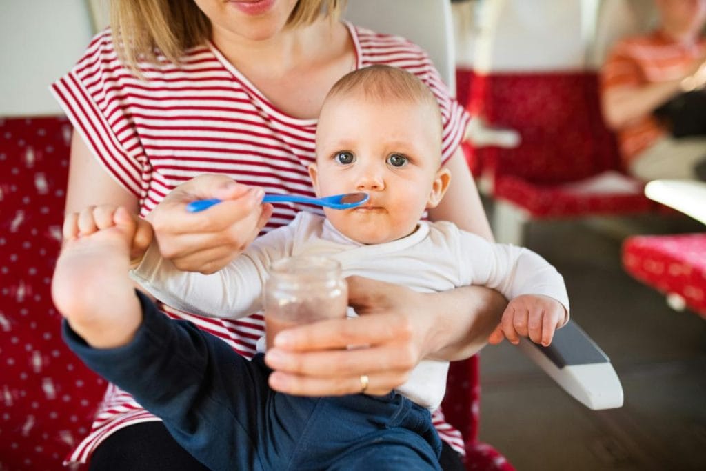 baby boy eating food from a spoon