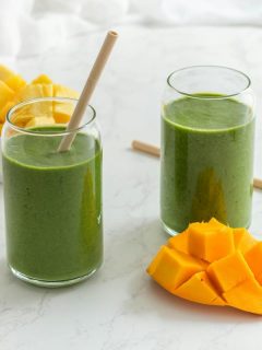 a tropical green shake made with pineapple mango and spinach