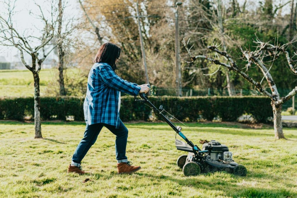 woman using a push mower