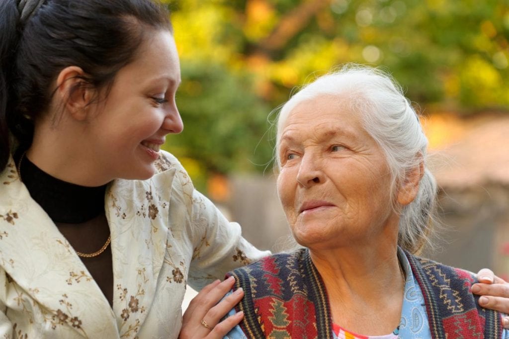 adult granddaughter and grandmother outdoors