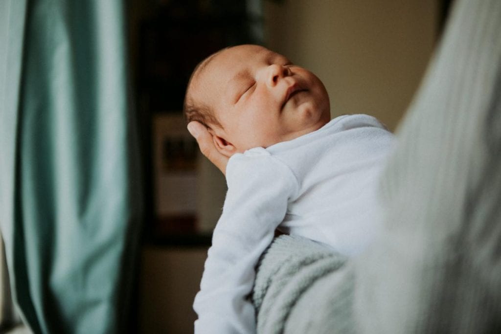 someone holding a sleeping baby