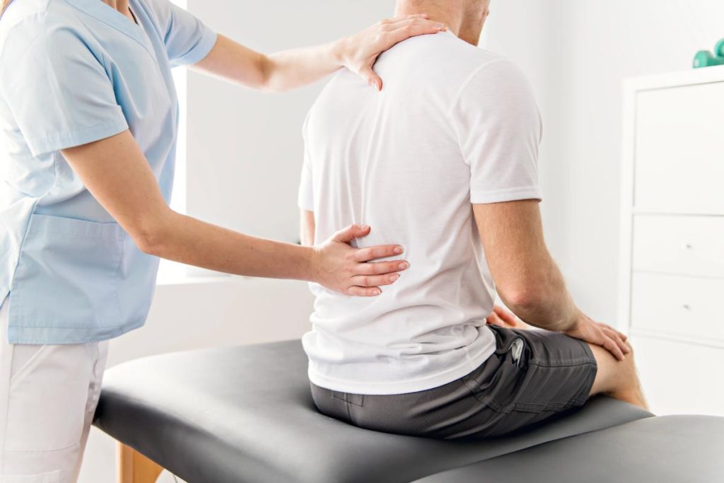 physiotherapist working on patient's back