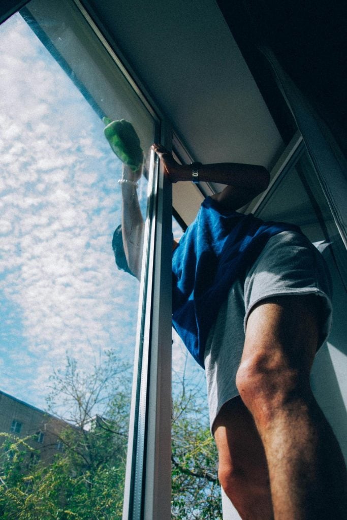 person cleaning windows