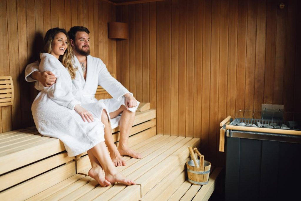 couples in robes in a sauna