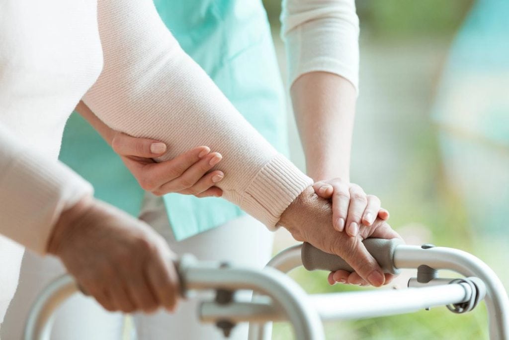 unidentified elderly woman using a walker