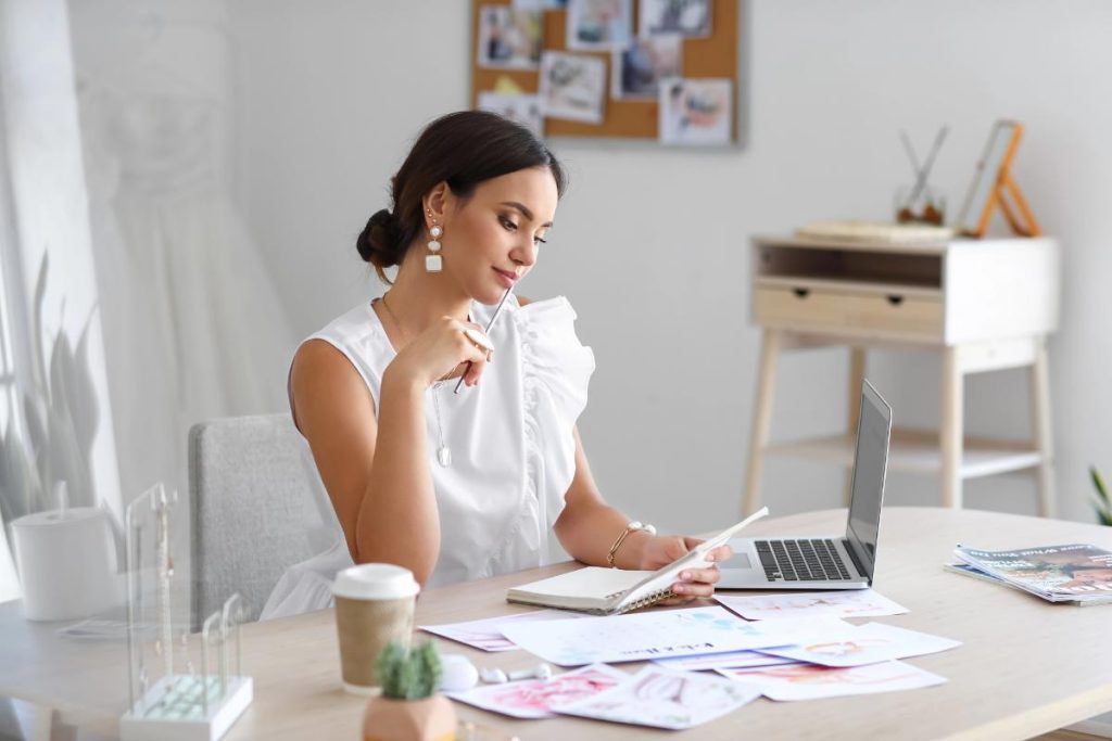 event planner looking at papers and laptop