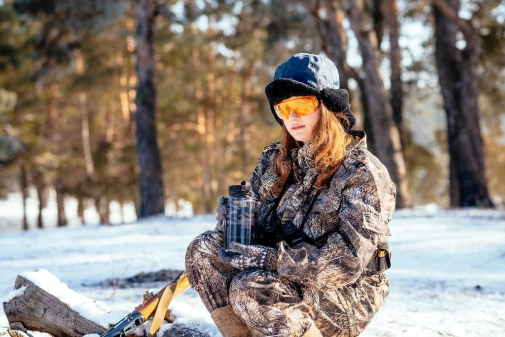 female hunter in the snow