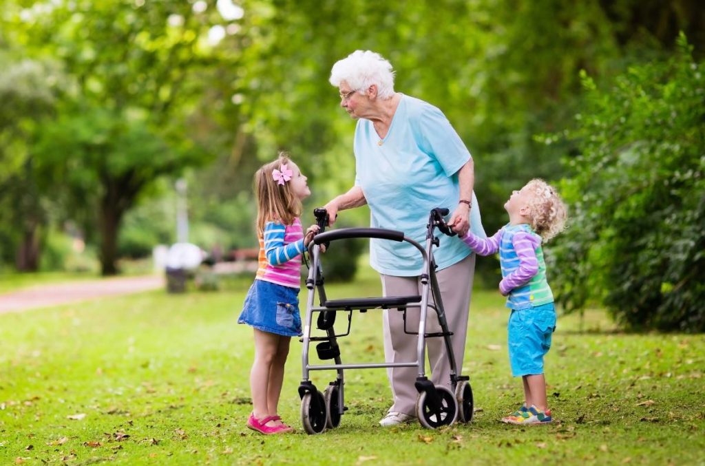 grandma using rollator walking with granddaughters