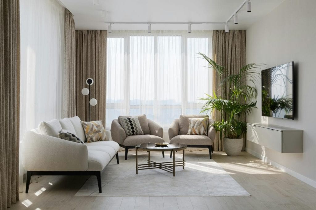 living room with modern furniture and long drapes