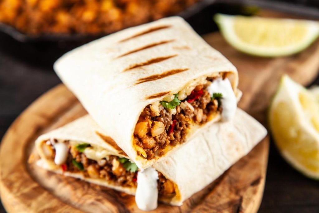 Mexican burrito on wooden cutting board