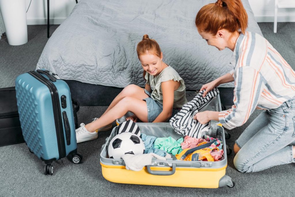 mother helping daughter pack for a trip