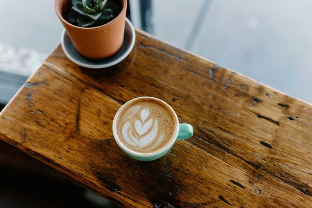 cup of cappuccino on wooden block