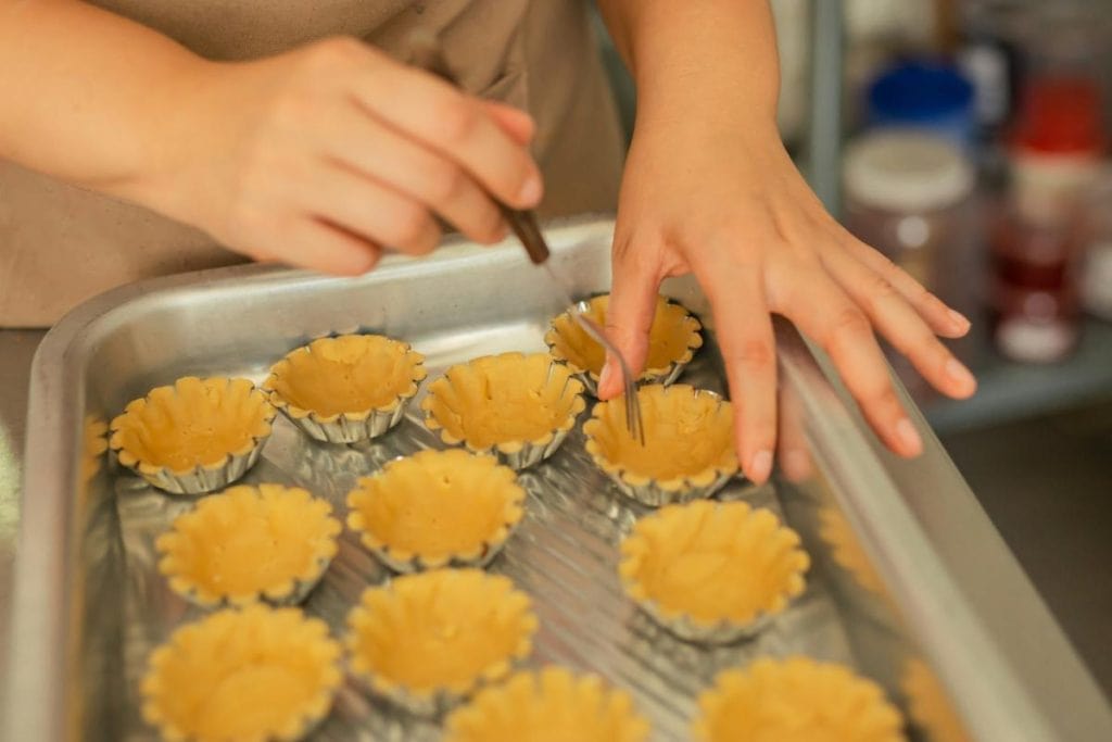 caterer preparing mini pie crusts