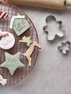 christmas cookies on a wire rack with meringue cookies ina bowl off to the side