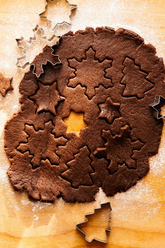 cookie dough with snowflake cookies cut out