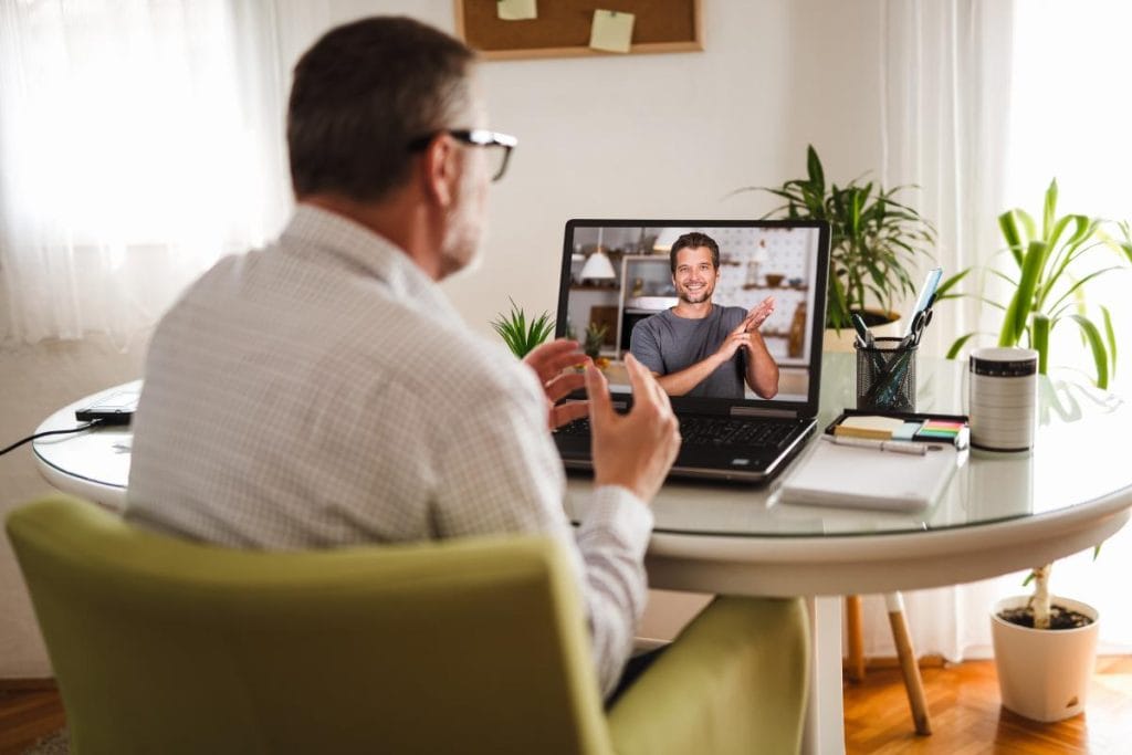 man on video call using sign language