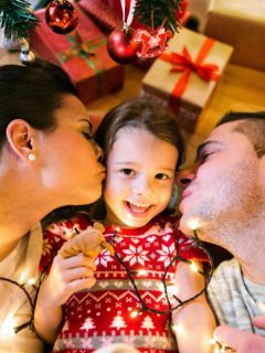 family photo under the tree with holiday lights