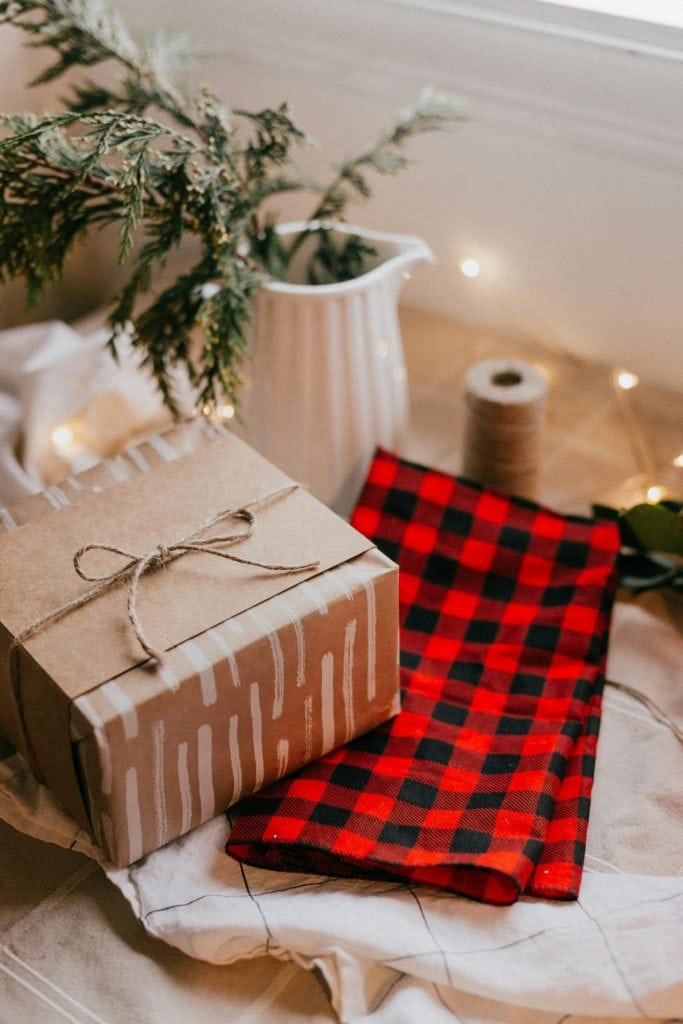 a gift wrapped in wrapping paper, kraft paper, and tied with twine