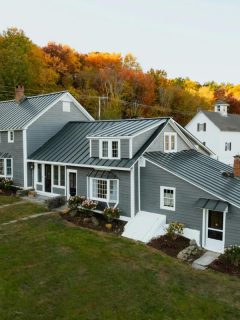 aerial view of a large gray house in autumn