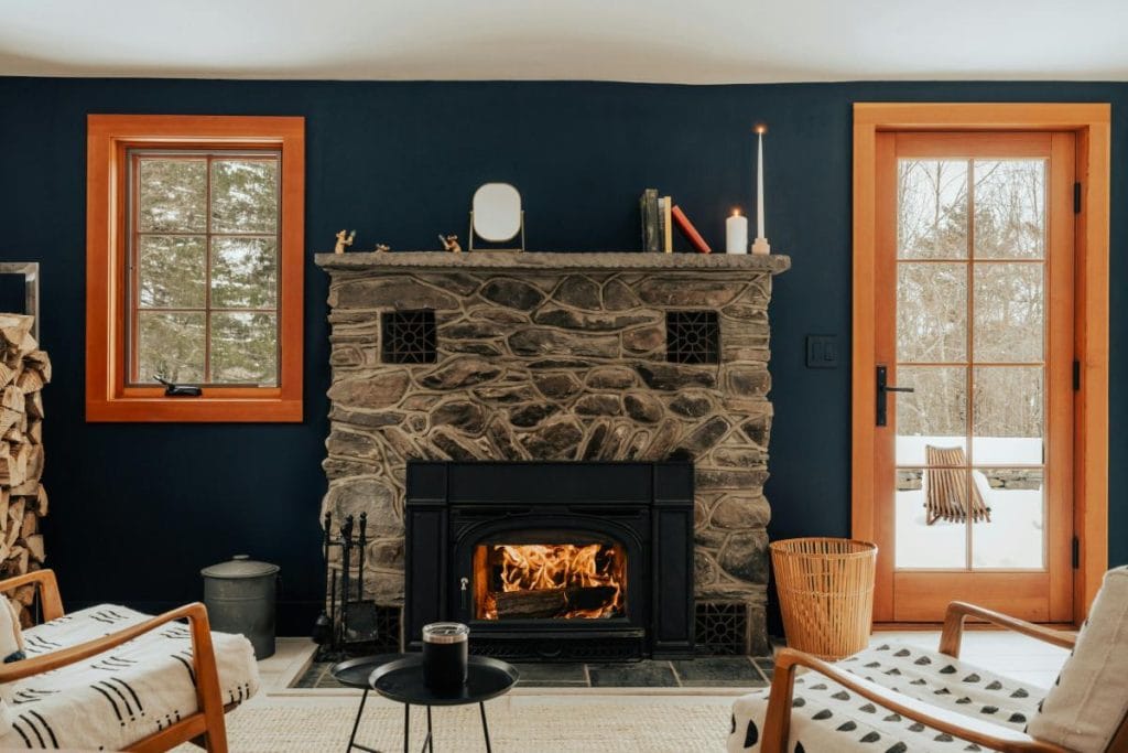 living room with fireplace and dark blue accent wall