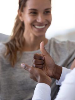 woman and man using sign language to communicate