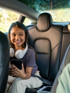 mom looking back at daughter as they're ready to leave on a road trip