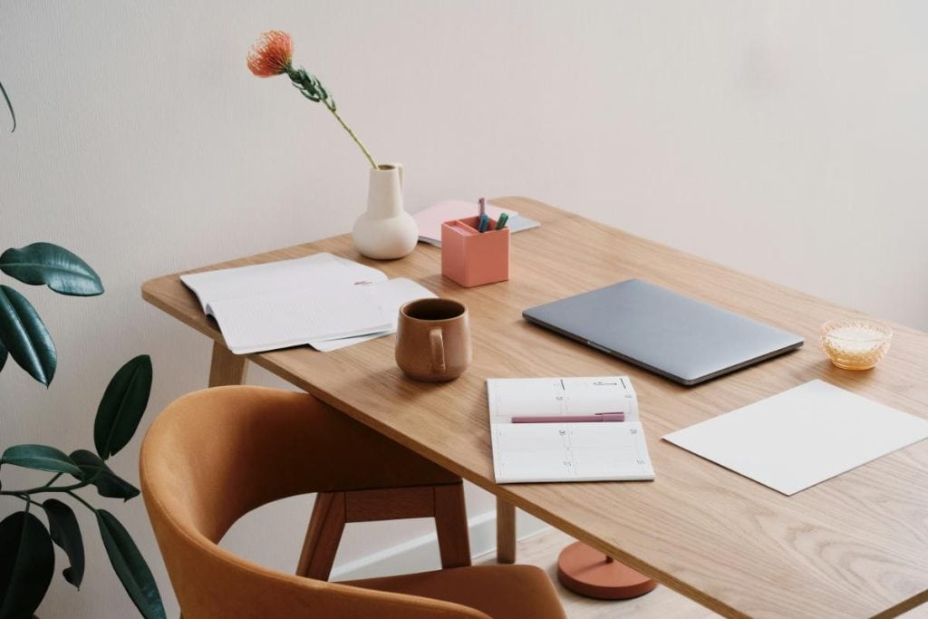 a desk with a laptop and office supplies