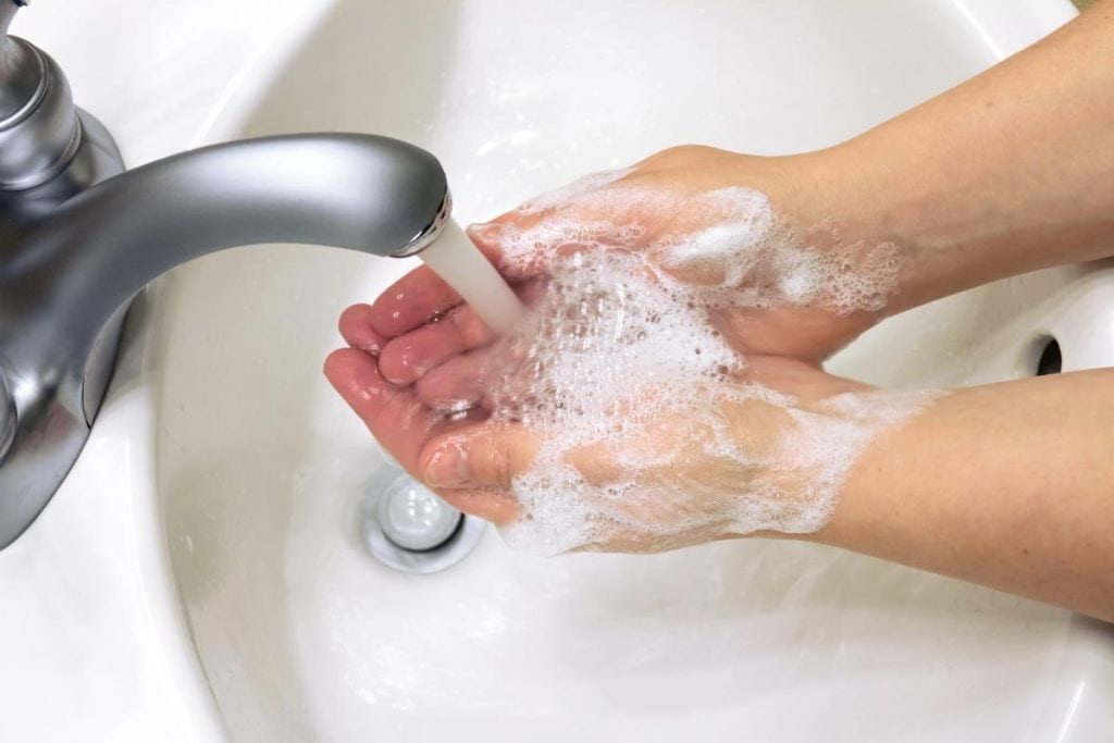 soapy hands under running water