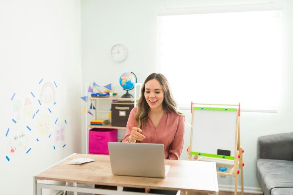 teacher using a laptop to teach lessons