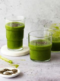 three glasses with green smoothie mixture inside