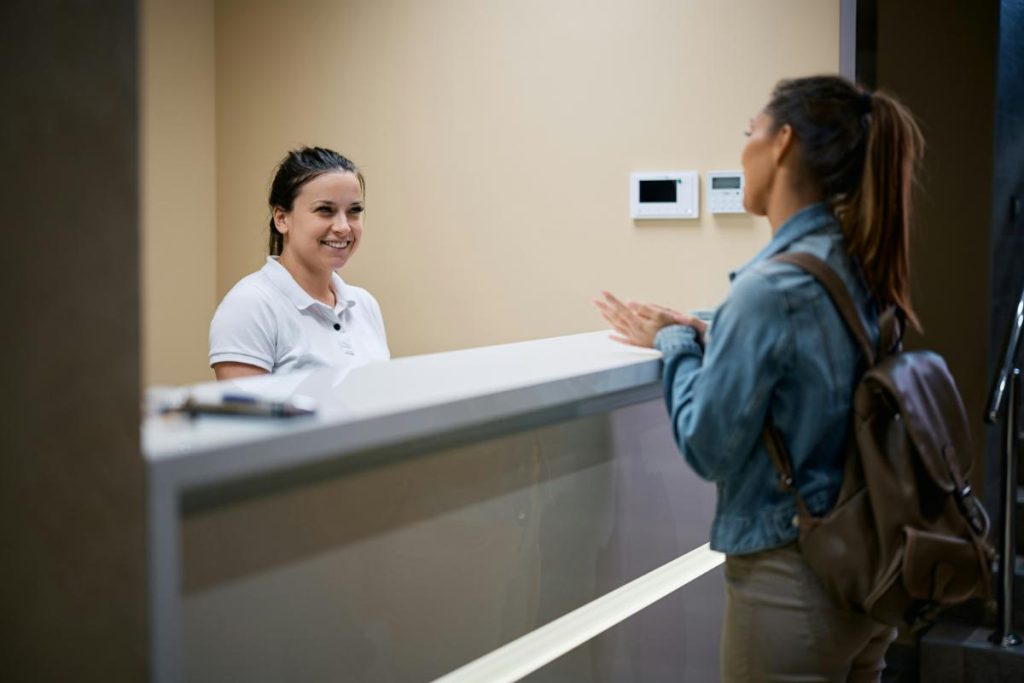 woman checking in with receptionist